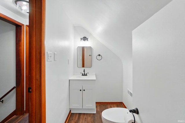3560 Sandpoint Rd, Fort Wayne, IN 46809 - half bath with wood finished floors, vanity, vaulted ceiling, toilet, and baseboards