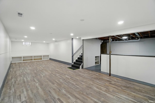 3560 Sandpoint Rd, Fort Wayne, IN 46809 - below grade area with wood finished floors, recessed lighting, stairs, and baseboards