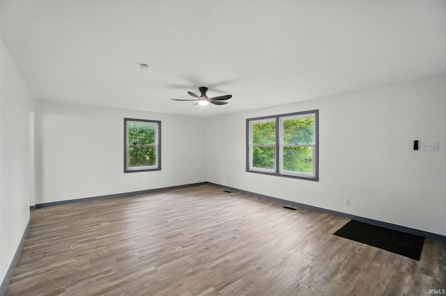 3560 Sandpoint Rd, Fort Wayne, IN 46809 - empty room with a ceiling fan, wood finished floors, and baseboards
