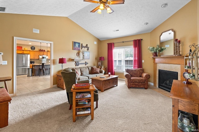 3934 Rushgrove Dr, Lafayette, IN 47909 - living area featuring light colored carpet, lofted ceiling, ceiling fan, a fireplace with flush hearth, and a textured ceiling