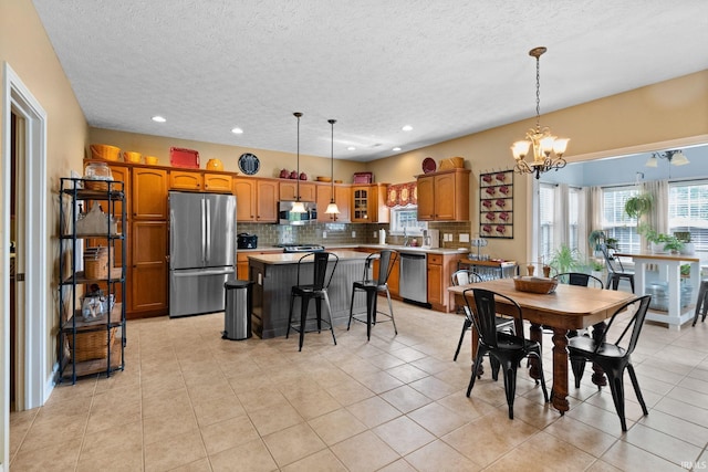 3934 Rushgrove Dr, Lafayette, IN 47909 - dining area with a chandelier, a textured ceiling, healthy amount of natural light, light tile patterned floors, and recessed lighting
