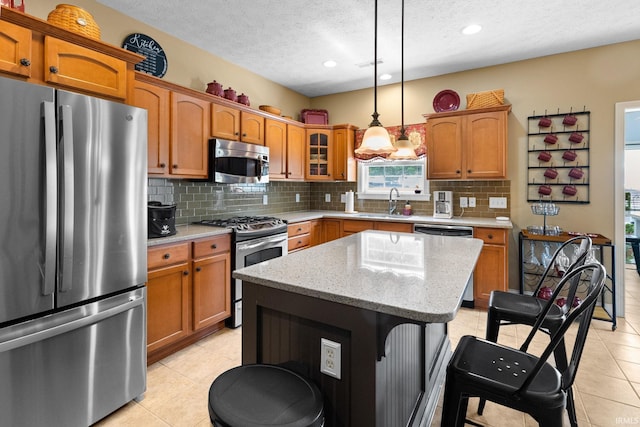 3934 Rushgrove Dr, Lafayette, IN 47909 - kitchen featuring appliances with stainless steel finishes, a textured ceiling, decorative backsplash, light tile patterned flooring, and brown cabinets
