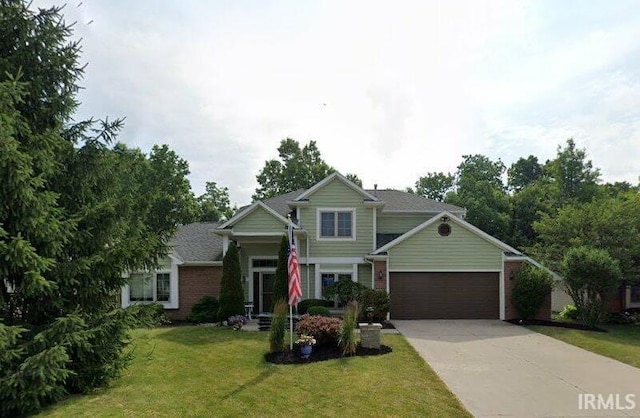 6326 Treasure Cv, Fort Wayne, IN 46835 - view of front of home with driveway, a front lawn, brick siding, and a garage