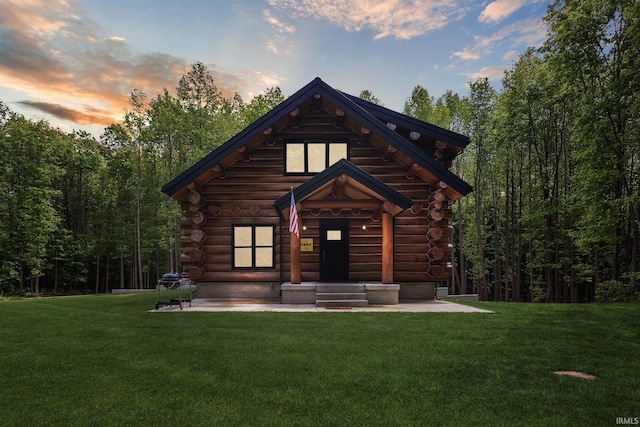 7428 E 400 N Rd, Rolling Prairie, IN 46371 - log-style house with log siding, a yard, and a view of trees