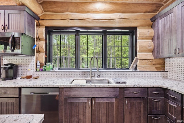 7428 E 400 N Rd, Rolling Prairie, IN 46371 - kitchen with stainless steel appliances, log walls, a sink, decorative backsplash, and dark brown cabinetry