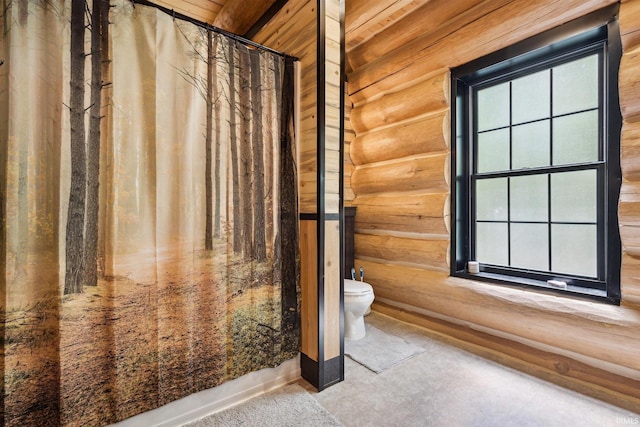 7428 E 400 N Rd, Rolling Prairie, IN 46371 - bathroom with log walls, toilet, and curtained shower