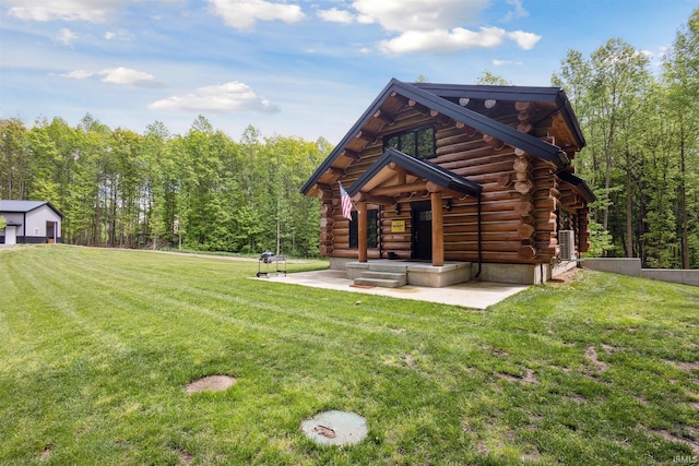 7428 E 400 N Rd, Rolling Prairie, IN 46371 - back of property featuring log exterior, a lawn, and a forest view