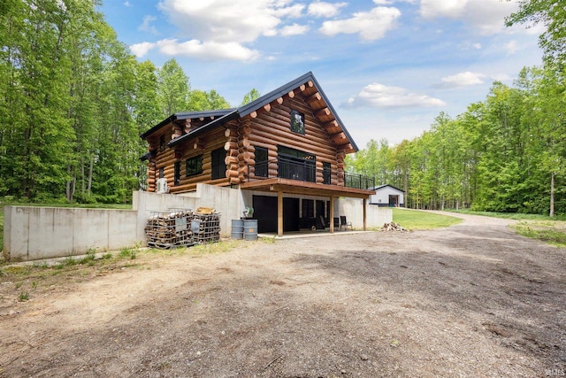 7428 E 400 N Rd, Rolling Prairie, IN 46371 - view of side of home with log siding and a view of trees