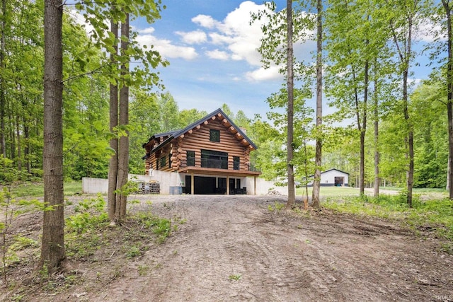 7428 E 400 N Rd, Rolling Prairie, IN 46371 - view of front of home featuring log exterior and dirt driveway