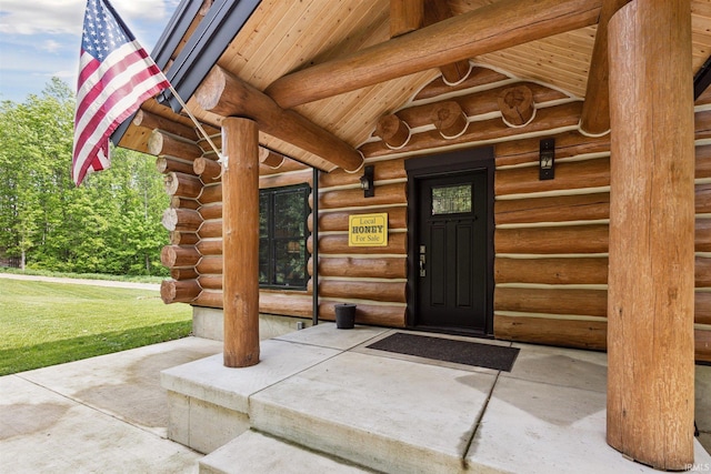 7428 E 400 N Rd, Rolling Prairie, IN 46371 - view of exterior entry with log siding and a yard