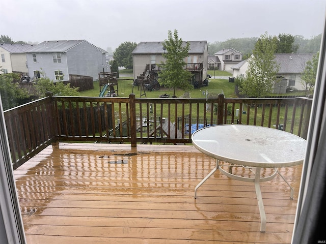 201 Riley Dr, Fort Wayne, IN 46825 - wooden deck featuring a playground, a residential view, and a lawn