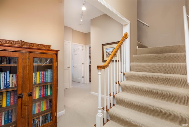 9838 Gulfstream Ct, Fishers, IN 46037 - stairway with carpet floors, baseboards, and track lighting
