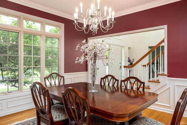 9838 Gulfstream Ct, Fishers, IN 46037 - dining area featuring a decorative wall, wainscoting, plenty of natural light, crown molding, and light wood finished floors