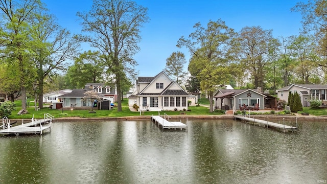 water view with a boat dock and nearby suburban area