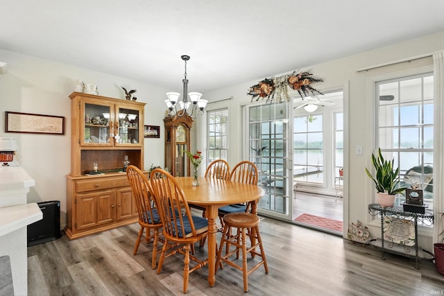 dining space with light wood-style flooring and a chandelier