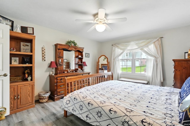 bedroom with light wood-type flooring and ceiling fan