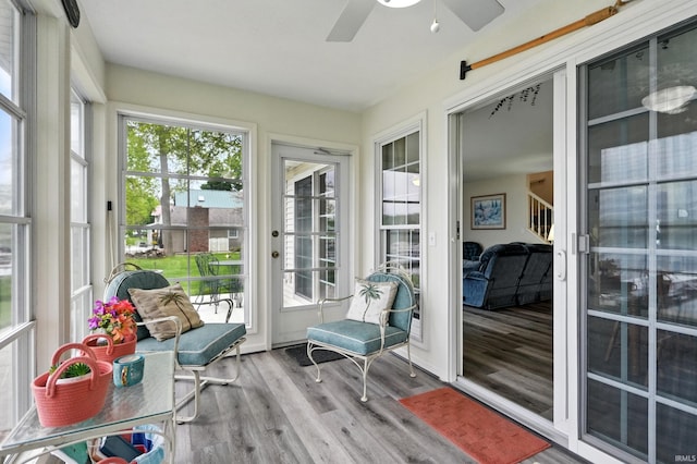 sunroom featuring ceiling fan