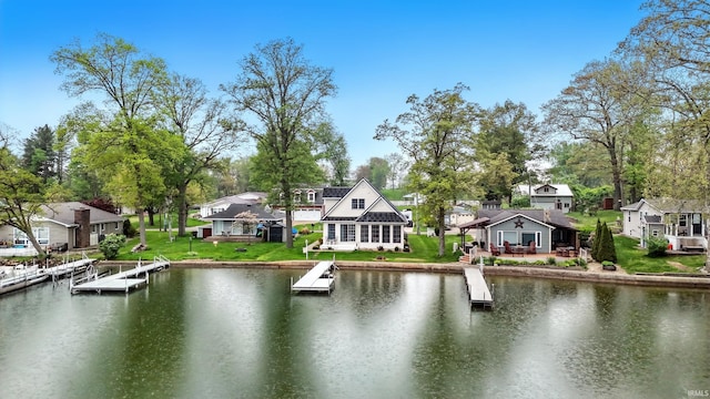water view featuring nearby suburban area and a dock