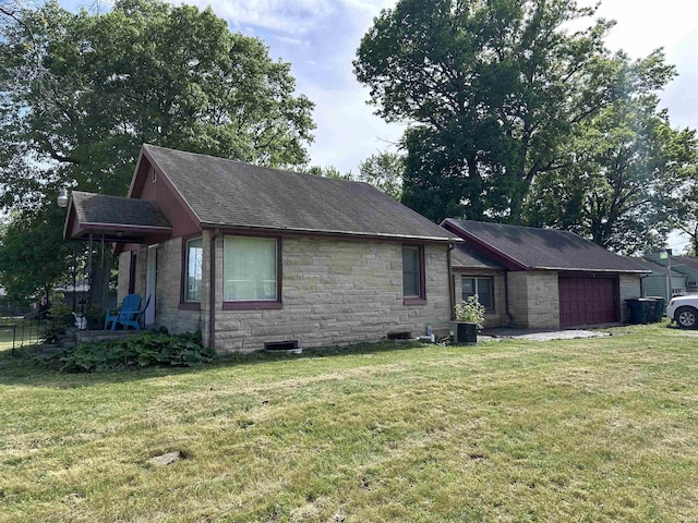 201 W Waid Ave, Muncie, IN 47303 - view of front of property featuring stone siding, a front yard, a garage, and roof with shingles