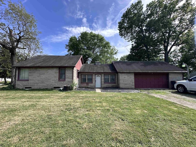 201 W Waid Ave, Muncie, IN 47303 - ranch-style house with stone siding, a garage, driveway, and a front lawn