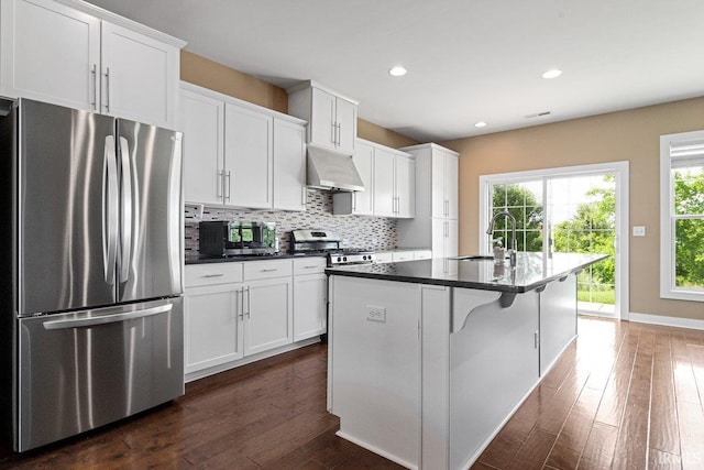 3102 Paradise Cir, Newburgh, IN 47630 - kitchen with appliances with stainless steel finishes, under cabinet range hood, a sink, dark countertops, and decorative backsplash