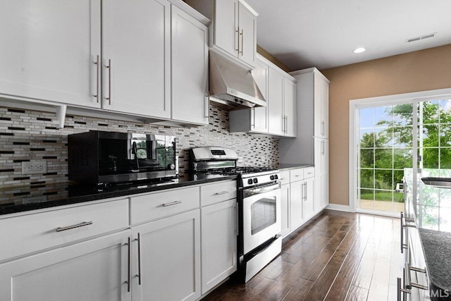 3102 Paradise Cir, Newburgh, IN 47630 - kitchen featuring appliances with stainless steel finishes, dark wood-style floors, decorative backsplash, white cabinets, and healthy amount of natural light