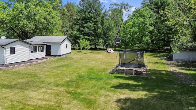 view of green lawn with a trampoline