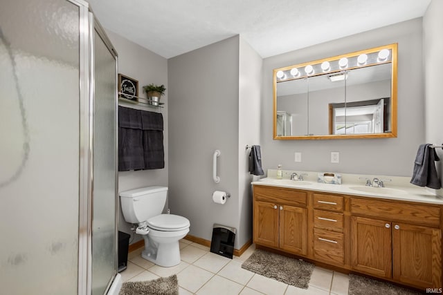 bathroom with a shower stall, tile patterned floors, toilet, and double vanity