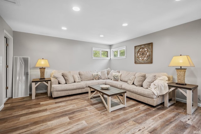 living room with recessed lighting, wood finished floors, and baseboards