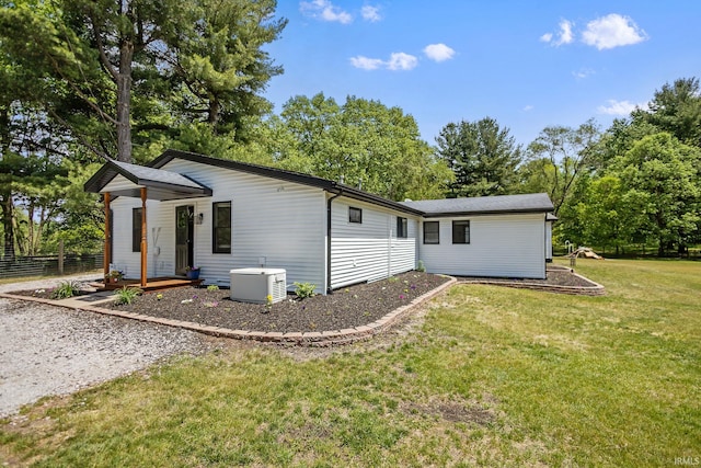 rear view of property featuring view of wooded area
