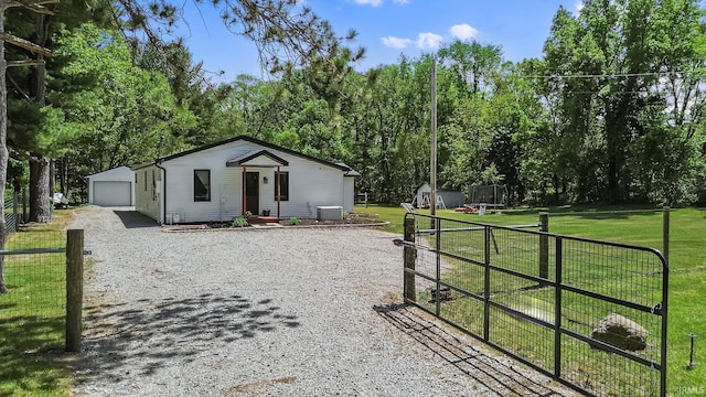 view of front of property with an outbuilding, driveway, and a detached garage