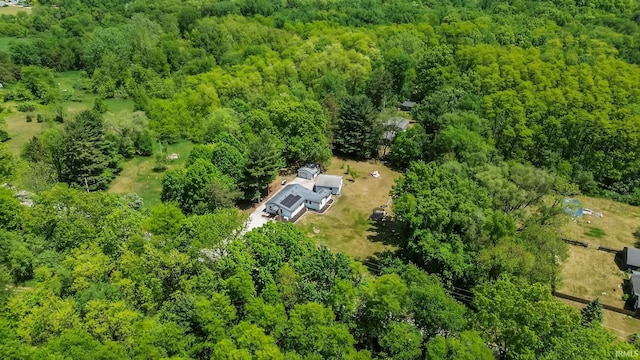 view of subject property with a heavily wooded area