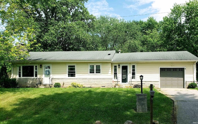 301 Raleigh Rd, Galveston, IN 46932 - ranch-style house featuring a garage, driveway, a front lawn, roof with shingles, and stone siding