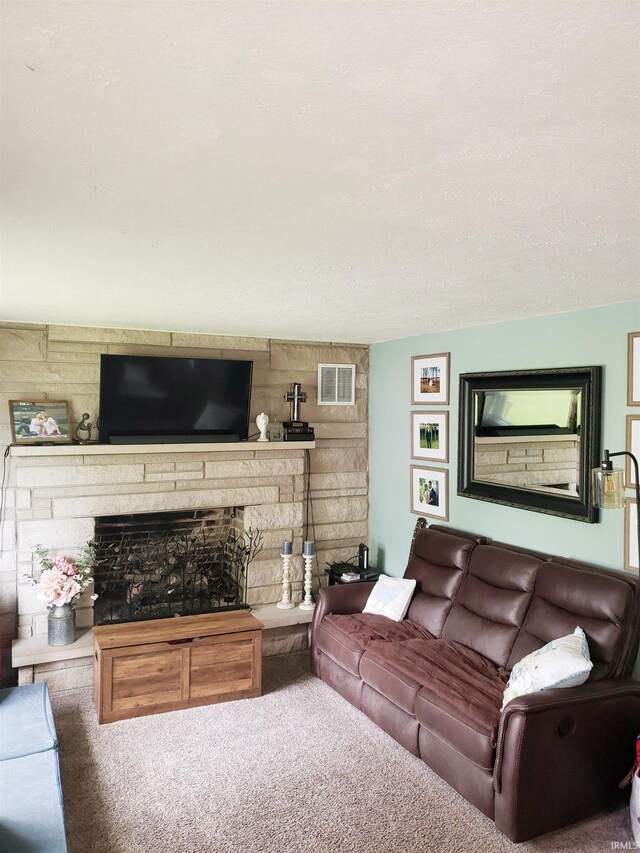 301 Raleigh Rd, Galveston, IN 46932 - carpeted living area with a stone fireplace