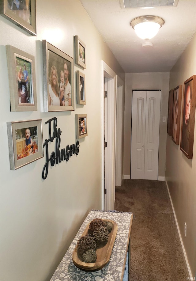 301 Raleigh Rd, Galveston, IN 46932 - hall with dark carpet and baseboards
