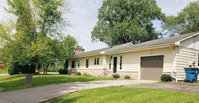 301 Raleigh Rd, Galveston, IN 46932 - ranch-style house featuring driveway, an attached garage, a chimney, and a front lawn