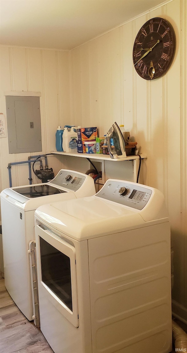 301 Raleigh Rd, Galveston, IN 46932 - washroom with electric panel, washer and dryer, light wood finished floors, and a decorative wall