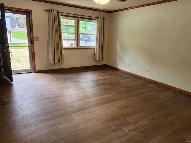 205 Holly Ln, Geneva, IN 46740 - unfurnished room featuring crown molding, wood-type flooring, a textured ceiling, baseboards, and a ceiling fan