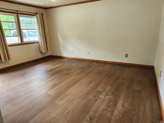 205 Holly Ln, Geneva, IN 46740 - empty room with crown molding, hardwood / wood-style flooring, and baseboards