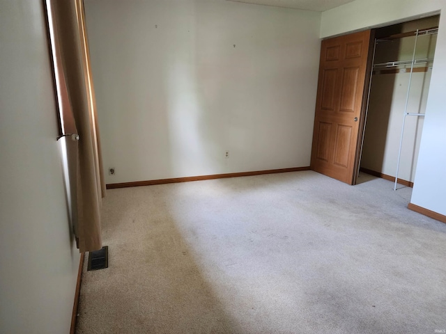 205 Holly Ln, Geneva, IN 46740 - unfurnished bedroom with light colored carpet, baseboards, and a closet