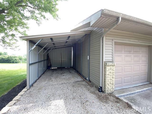 205 Holly Ln, Geneva, IN 46740 - garage featuring driveway and a carport