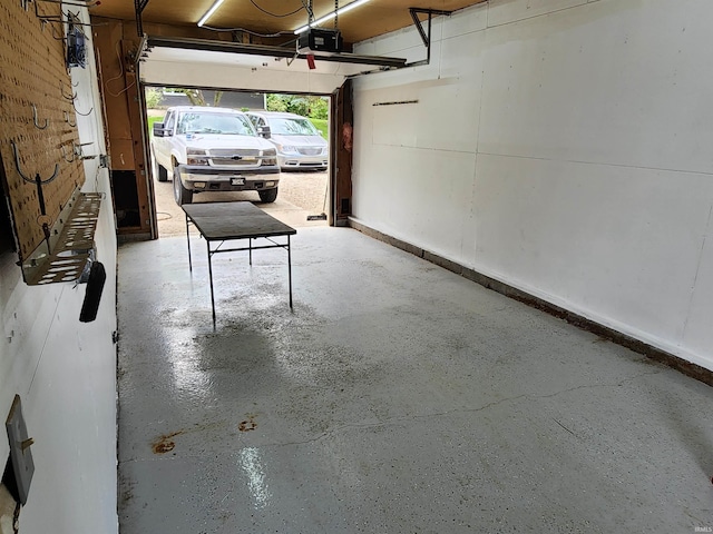 205 Holly Ln, Geneva, IN 46740 - garage with a garage door opener and baseboards