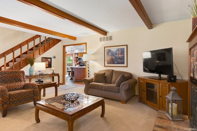 103 Ironwood Ave, Kendallville, IN 46755 - living area with beam ceiling, stairway, and light carpet