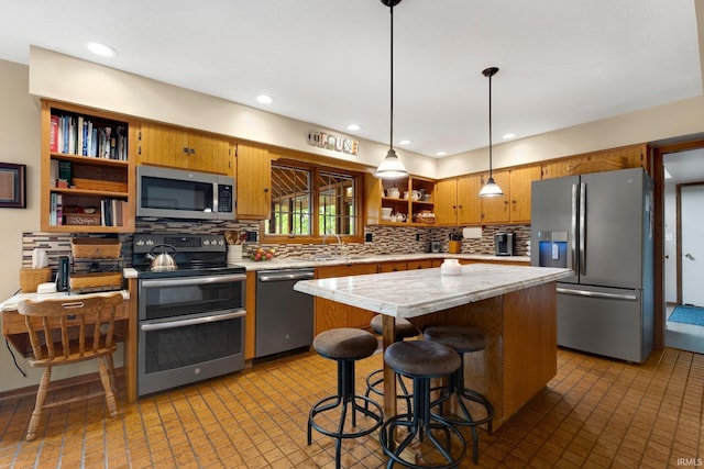 103 Ironwood Ave, Kendallville, IN 46755 - kitchen featuring stainless steel appliances, open shelves, light countertops, backsplash, and a center island
