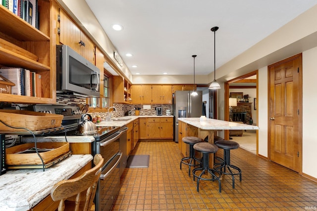 103 Ironwood Ave, Kendallville, IN 46755 - kitchen featuring appliances with stainless steel finishes, light countertops, a sink, backsplash, and recessed lighting