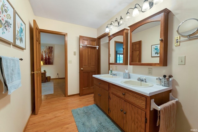 103 Ironwood Ave, Kendallville, IN 46755 - full bathroom featuring double vanity, wood finished floors, and baseboards
