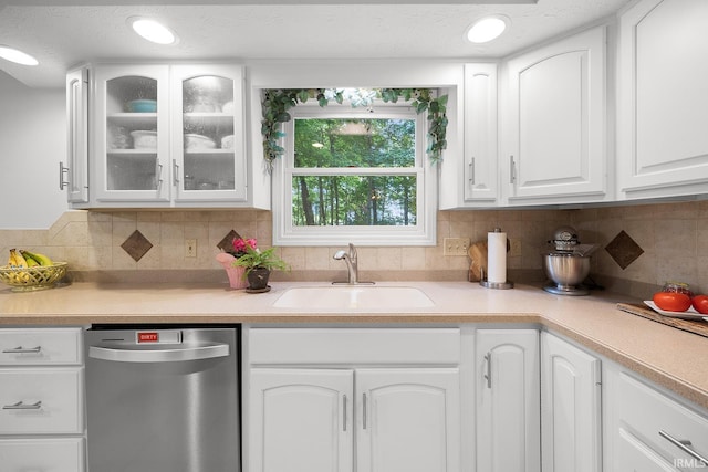 125 Durkees Run Dr, Lafayette, IN 47905 - kitchen with stainless steel dishwasher, a sink, white cabinetry, glass insert cabinets, and light countertops