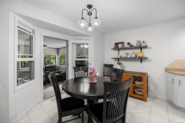 125 Durkees Run Dr, Lafayette, IN 47905 - dining space with baseboards, light tile patterned floors, and a chandelier