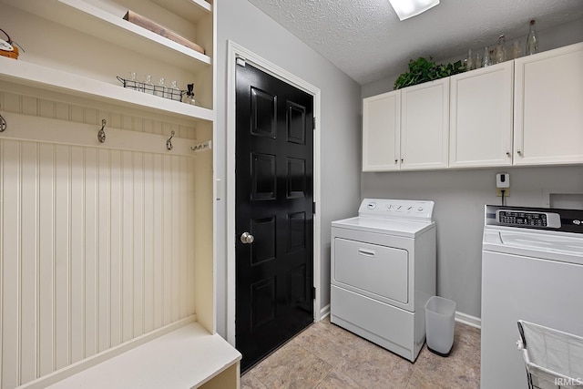 125 Durkees Run Dr, Lafayette, IN 47905 - laundry room with washing machine and dryer, cabinet space, a textured ceiling, and baseboards