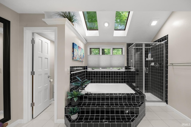 125 Durkees Run Dr, Lafayette, IN 47905 - bathroom with tile patterned floors, a shower stall, a skylight, a garden tub, and baseboards